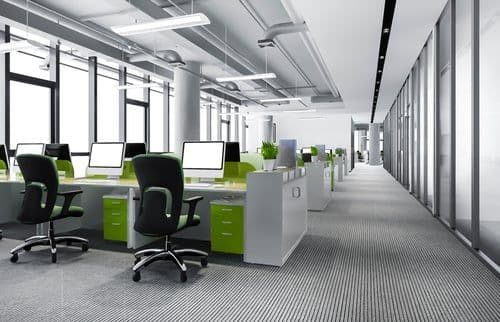 Clean open-plan office with tidy workstations maintained by a commercial cleaning service