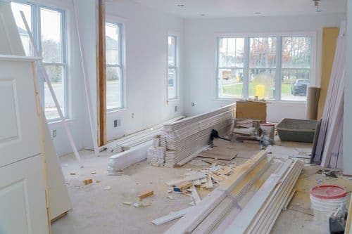 Interior of a home renovation covered in fine construction dust and trim debris