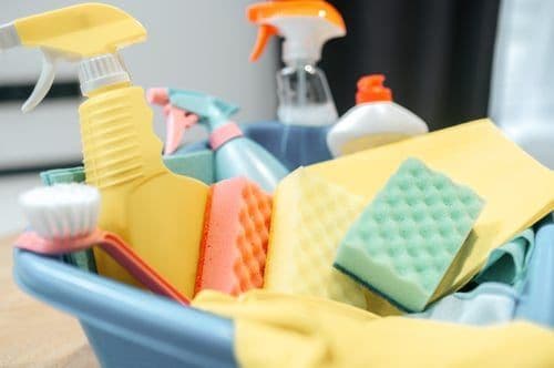 Cleaning caddy stocked with sponges and sprays ready for a recurring cleaning visit