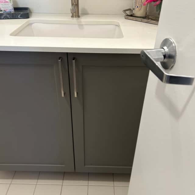 Close-up of a white vanity countertop and grey cabinet doors after cleaning — Ferrer Cleaning, Chicago, IL
