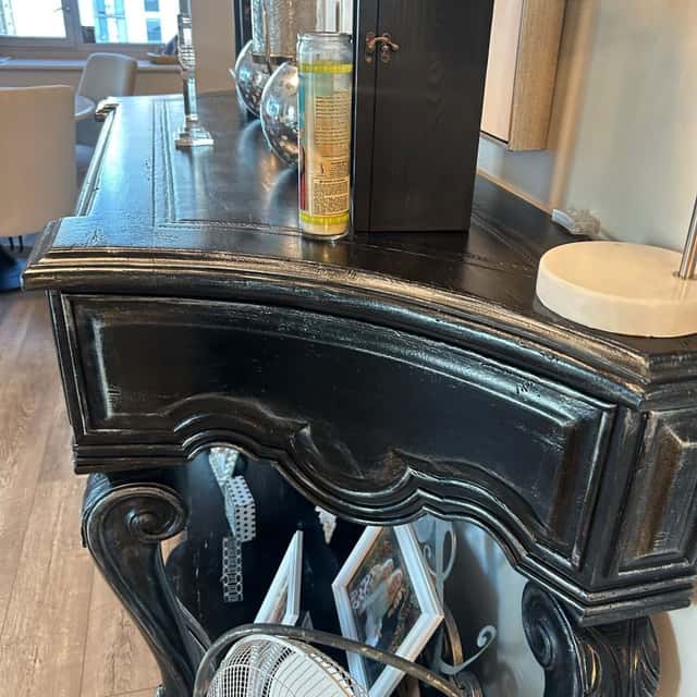 Detail of an ornate black carved cabinet, dusted and polished — Ferrer Cleaning, Chicago, IL
