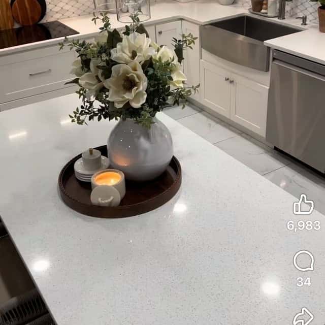 White quartz kitchen counter with a farmhouse sink and a vase of flowers after cleaning — Ferrer Cleaning, Chicago, IL