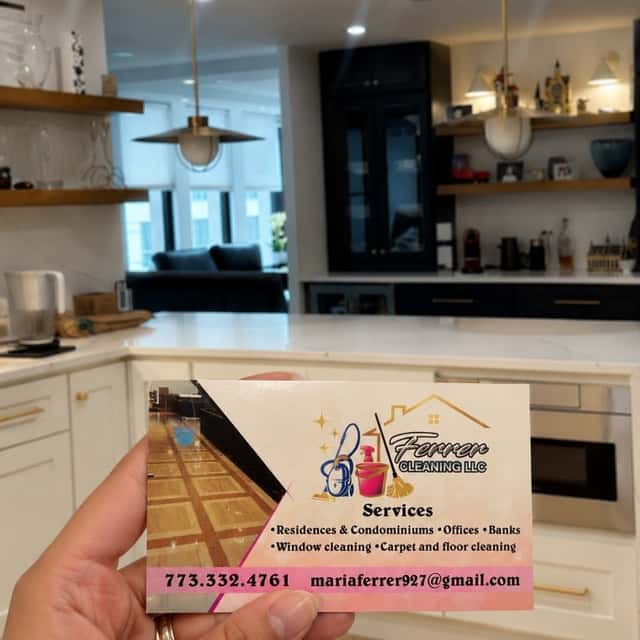 Ferrer Cleaning business card held up in a cleaned kitchen with open shelving — Ferrer Cleaning, Chicago, IL